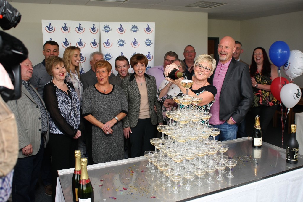 East Midlands Lottery winners gaze at the champagne tower.